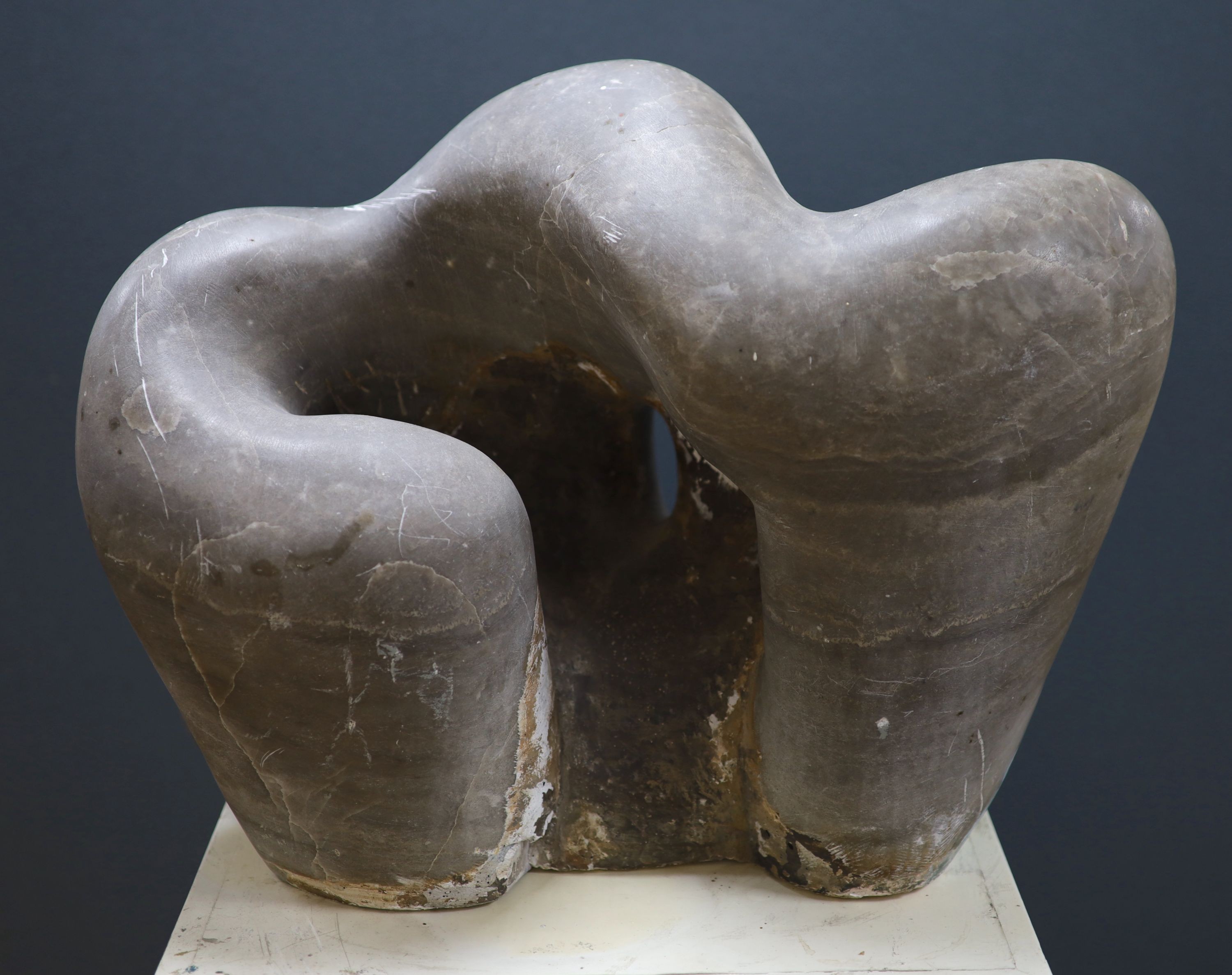 Wilby Hart, grey marble sculpture, abstract form, W 46cm. H 35cm. on a painted wood pedestal.